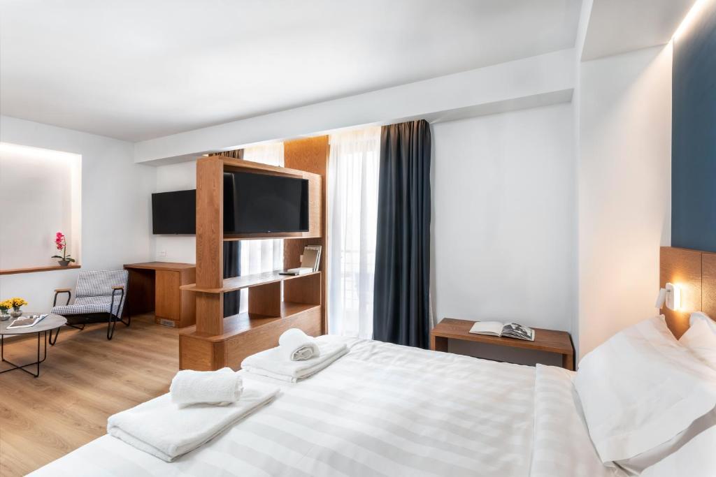 Postel nebo postele na pokoji v ubytování DAYS City Suites