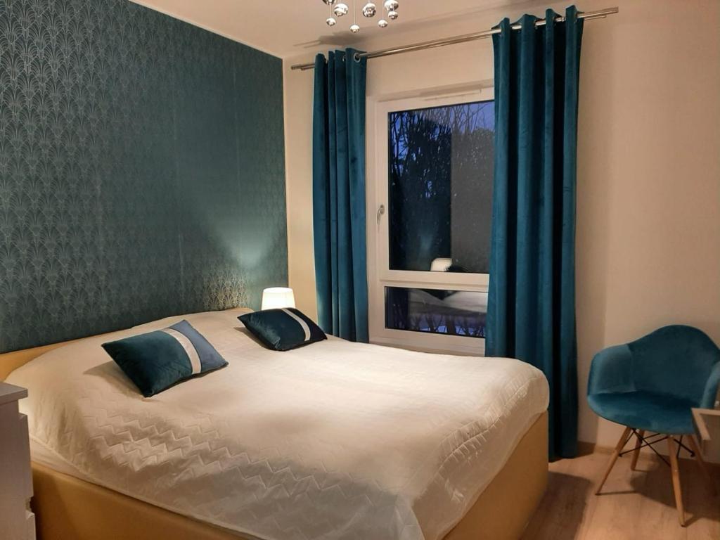 Posteľ alebo postele v izbe v ubytovaní Apartament NaGrobli