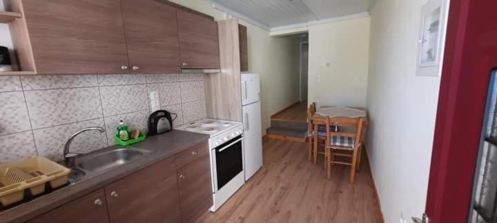 a kitchen with a sink and a stove top oven at Manto Apartments Lefkada in Évyiros