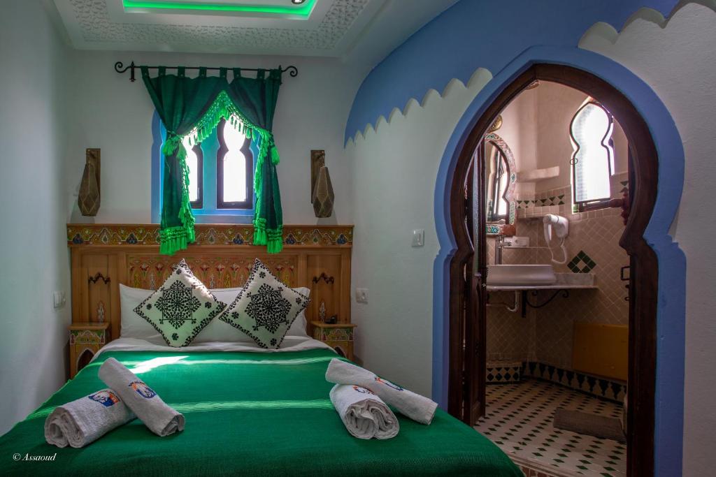 Postel nebo postele na pokoji v ubytování Hotel Dar Mounir