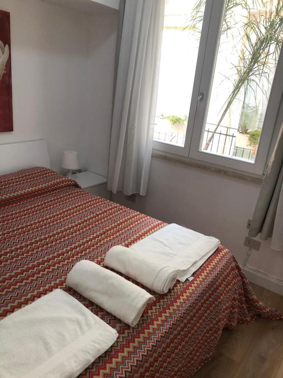 a bedroom with a bed with three towels on it at La Terrazza in Marsala