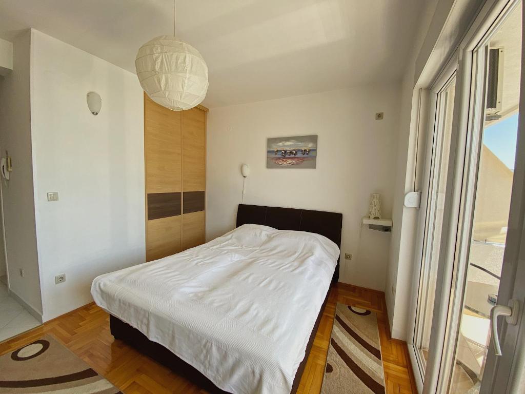 Postel nebo postele na pokoji v ubytování Apartments Bellevue - Otasevic
