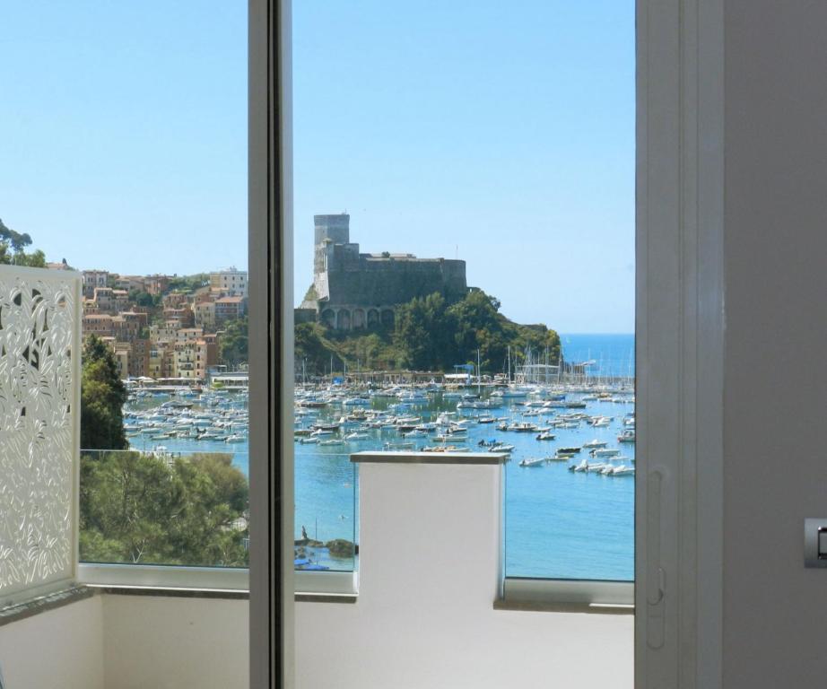 a window with a view of a harbor with boats at Hotel Byron in Lerici