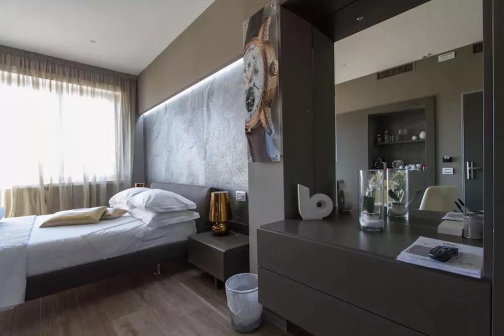Postel nebo postele na pokoji v ubytování Ginevra Rooms