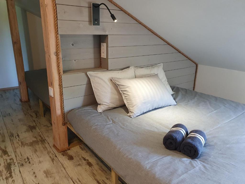 a bed with two mugs on top of it at KK Apartment city in Ventspils