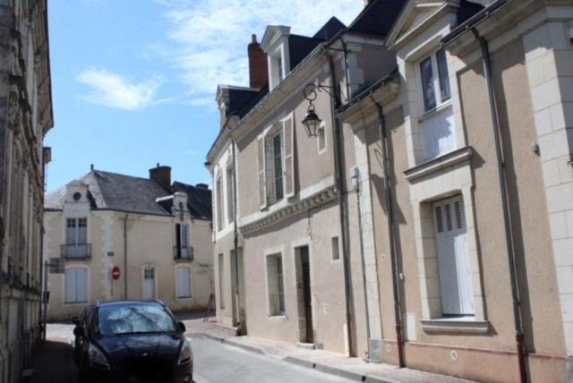 a car parked on a street next to buildings at Gîte du fil, Le Lude in Le Lude