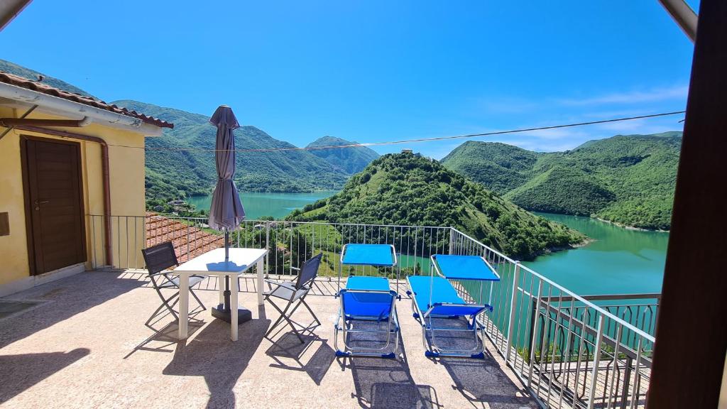 a balcony with a table and chairs and a view of a river at Amazing Lake View in Castel di Tora