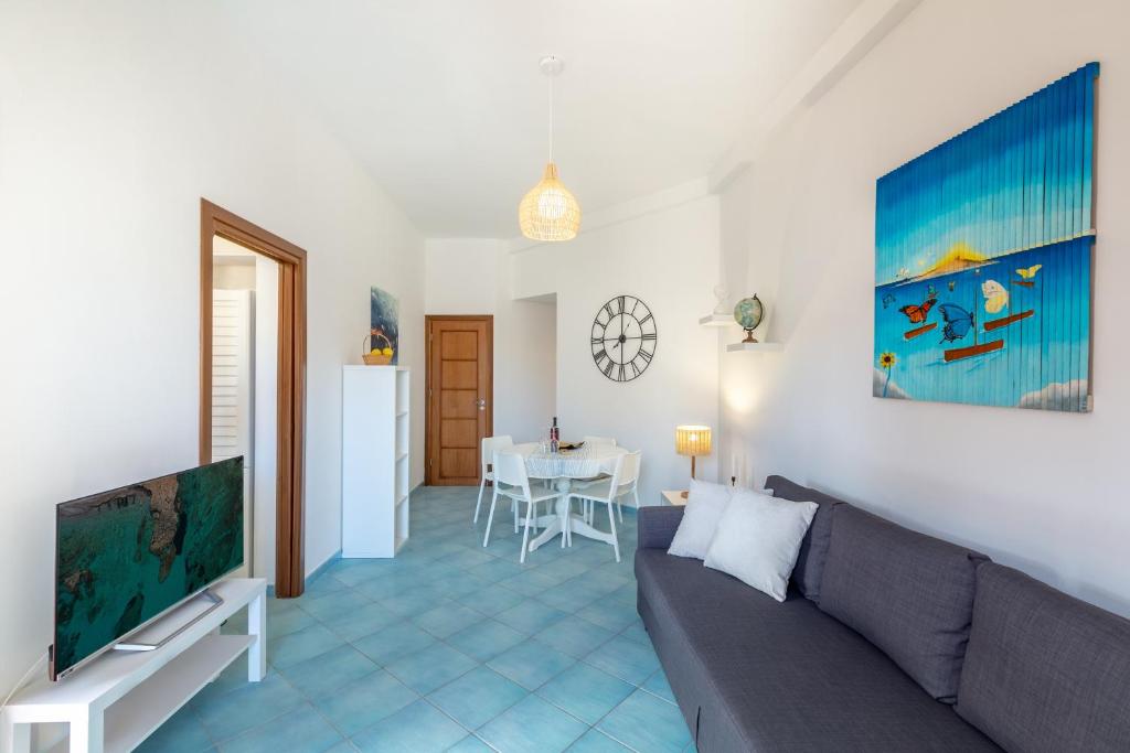 a living room with a couch and a table at Holiday Home La Notte Stellata in San Vito lo Capo