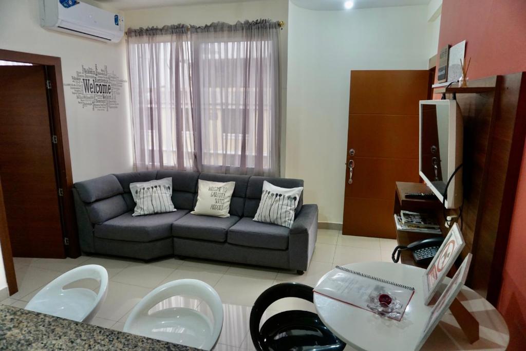 a living room with a couch and a table at Garzota Suites Airport in Guayaquil