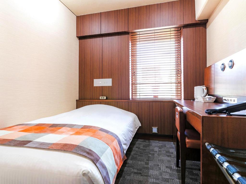 Postel nebo postele na pokoji v ubytování Central Hotel Okayama