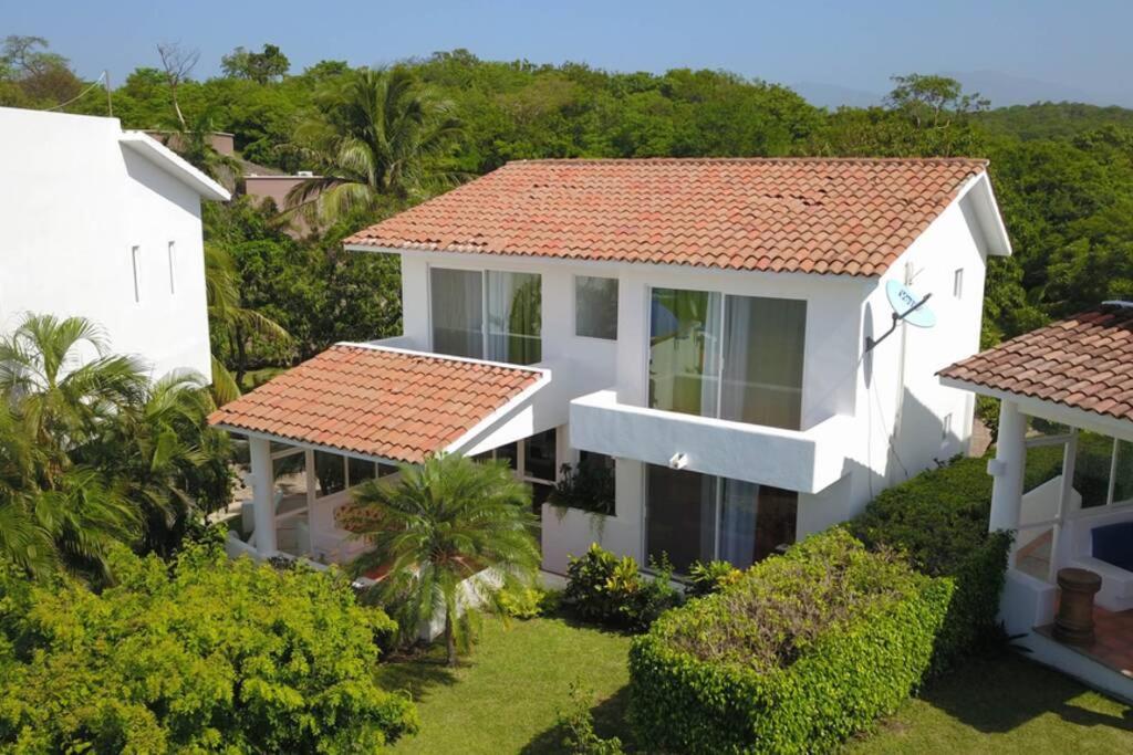 an aerial view of a white house with a red roof at Tehuana l House, Ocean view, pool. in Tangolunda