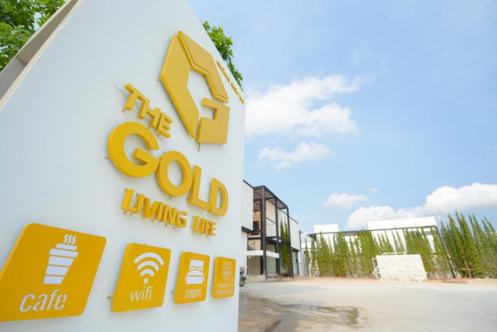 a sign for the companys gold living life at The Gold Living Life in Thung Song