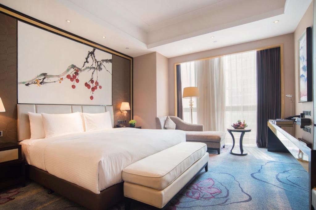 Postel nebo postele na pokoji v ubytování Wanda Realm Guangzhou Zengcheng