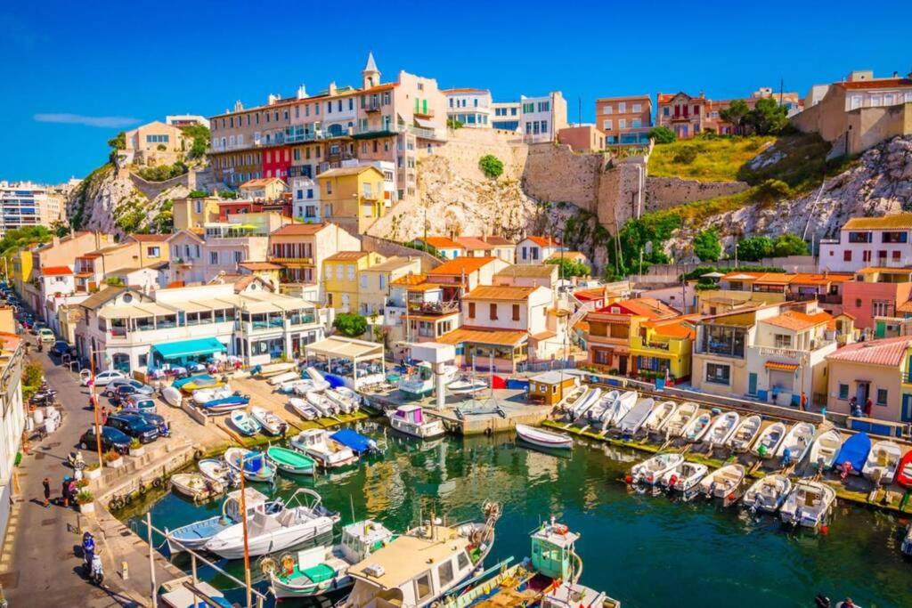 a group of boats docked in a harbor at Une calanque au coeur de la ville in Marseille