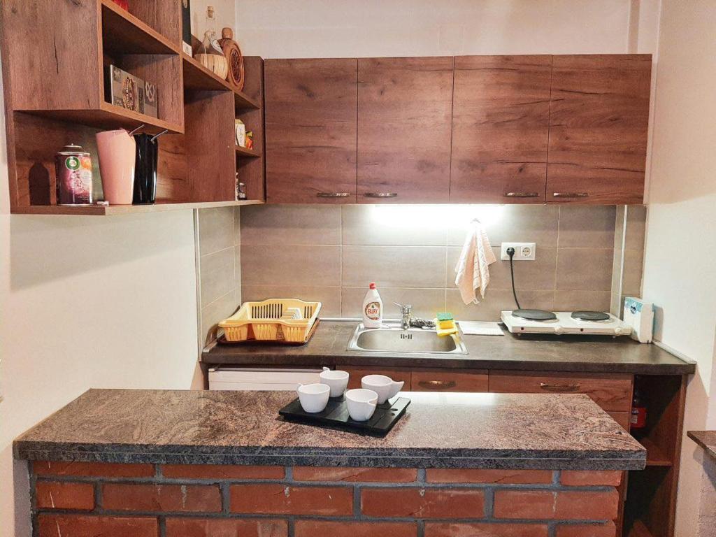 a kitchen with a counter with cups on a tray at DS center apartment in Ohrid