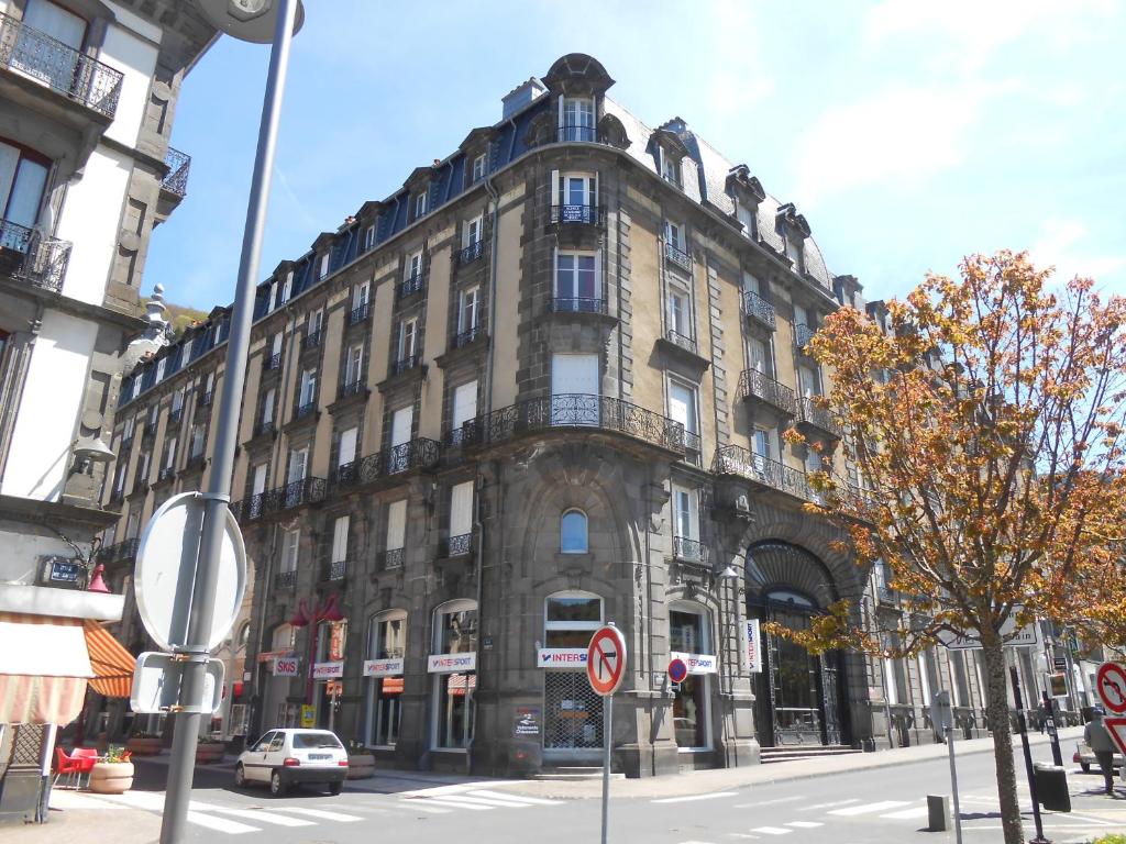 a large building on the corner of a street at Le Sarciron in Le Mont-Dore