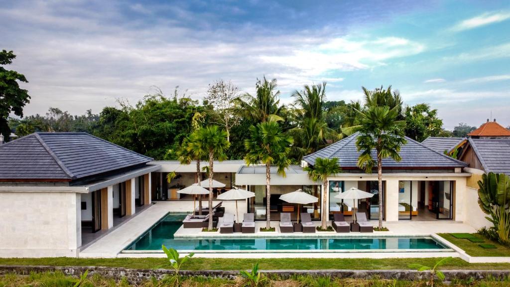 an exterior view of a villa with a swimming pool at Villa Yallan by BaliSuperHost in Ubud