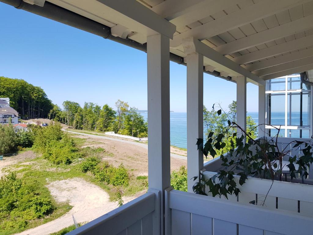 a view of the beach from the porch of a house at Studio 23, Residenz Seeblick in Ostseebad Sellin