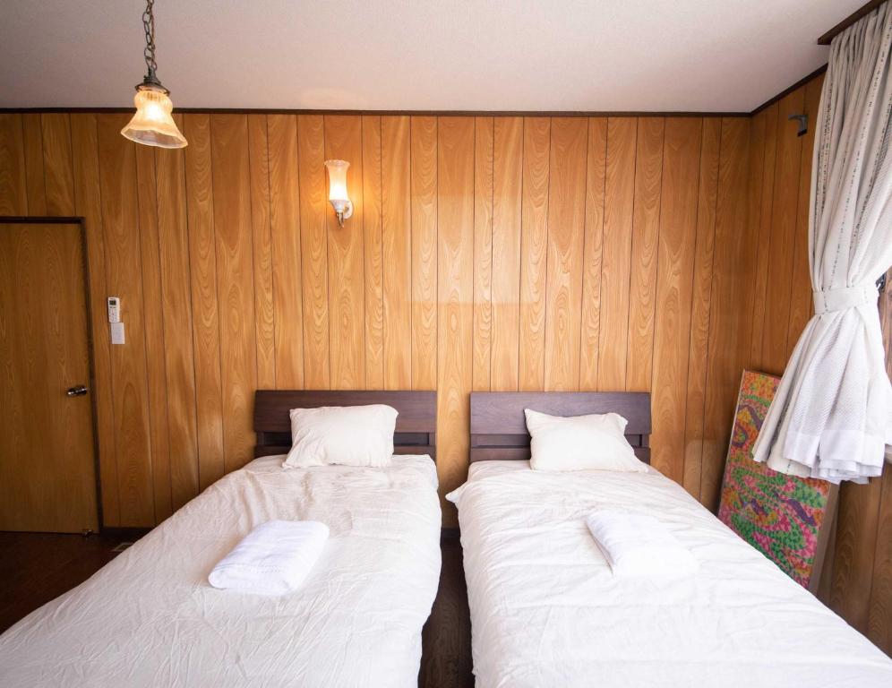 Postel nebo postele na pokoji v ubytování tune Hostel（ツネホステル館山）