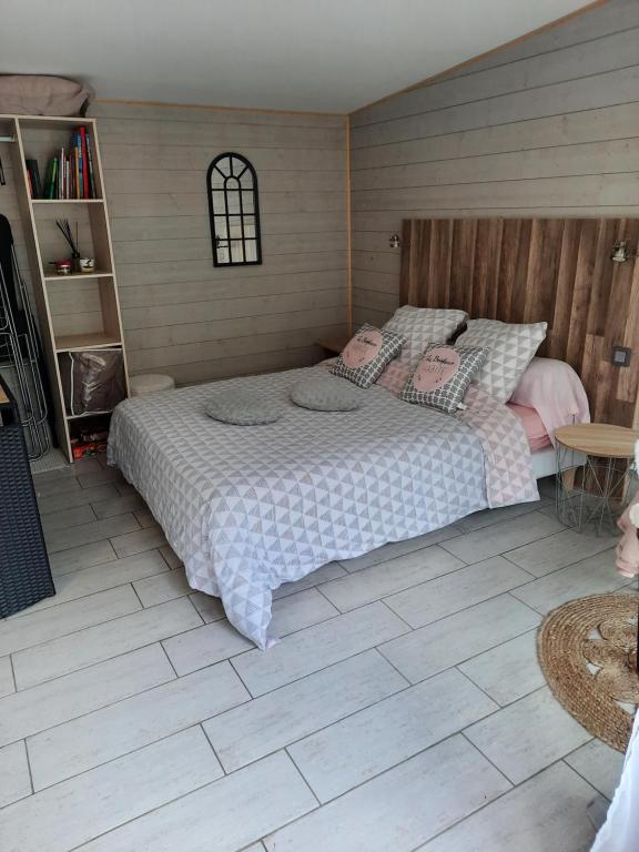 a bedroom with a large bed in a room at Les nids des falaises in Saint-Jouin-Bruneval