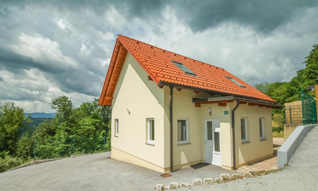 a small house with an orange roof at Holiday Home BOR in Podčetrtek