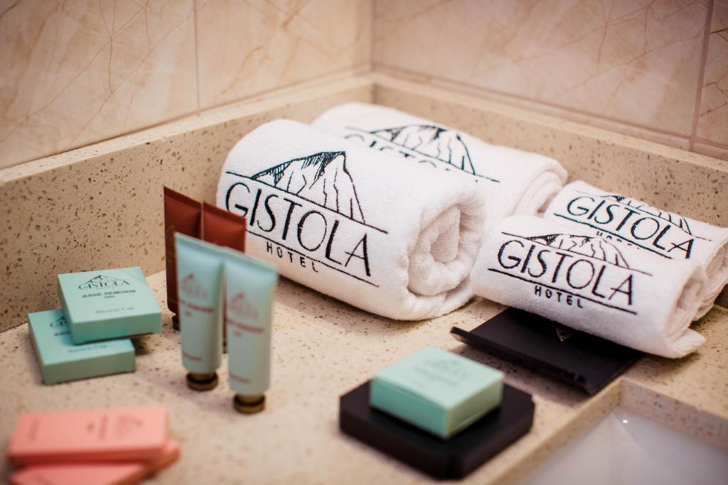 two towels on a counter in a bathroom at Gistola Hotel Mestia in Mestia