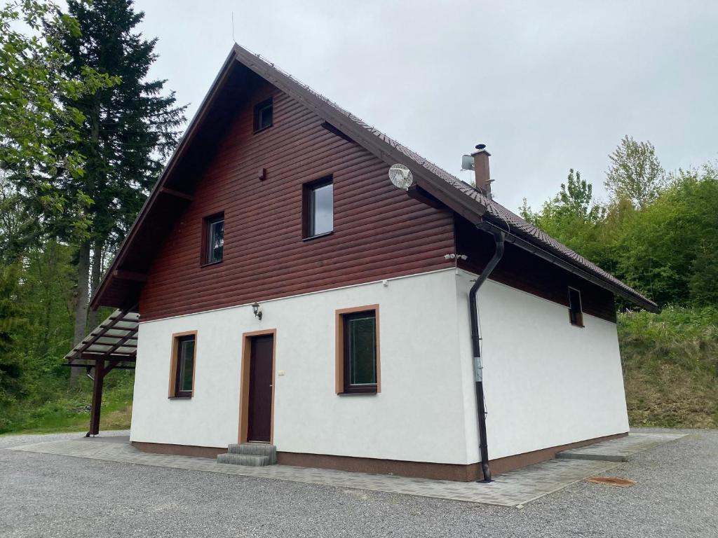 a white house with a brown roof at Chata Slanica in Námestovo