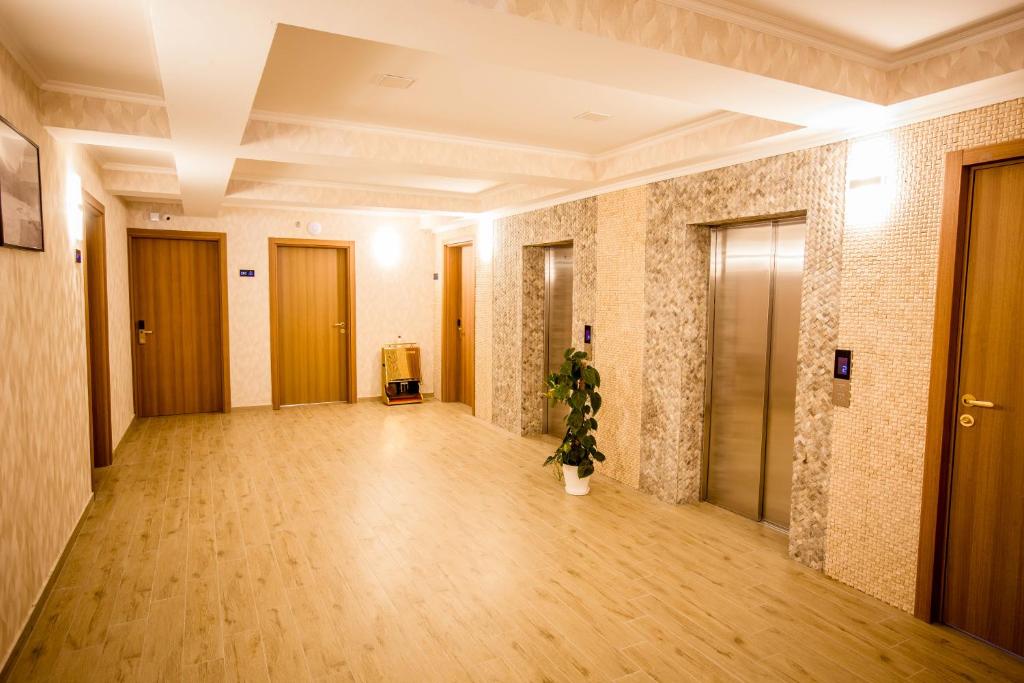 an empty hallway with a plant in a room at Gistola Hotel Mestia in Mestia