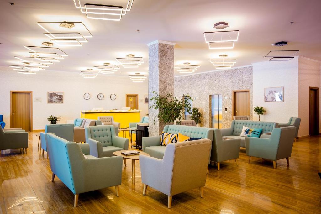 a waiting room with couches and chairs in a hospital at Gistola Hotel Mestia in Mestia