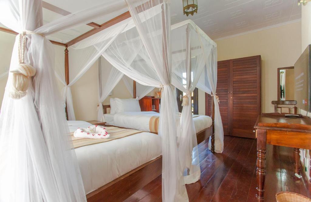 Postel nebo postele na pokoji v ubytování Mzima Beach Residences - Diani Beach