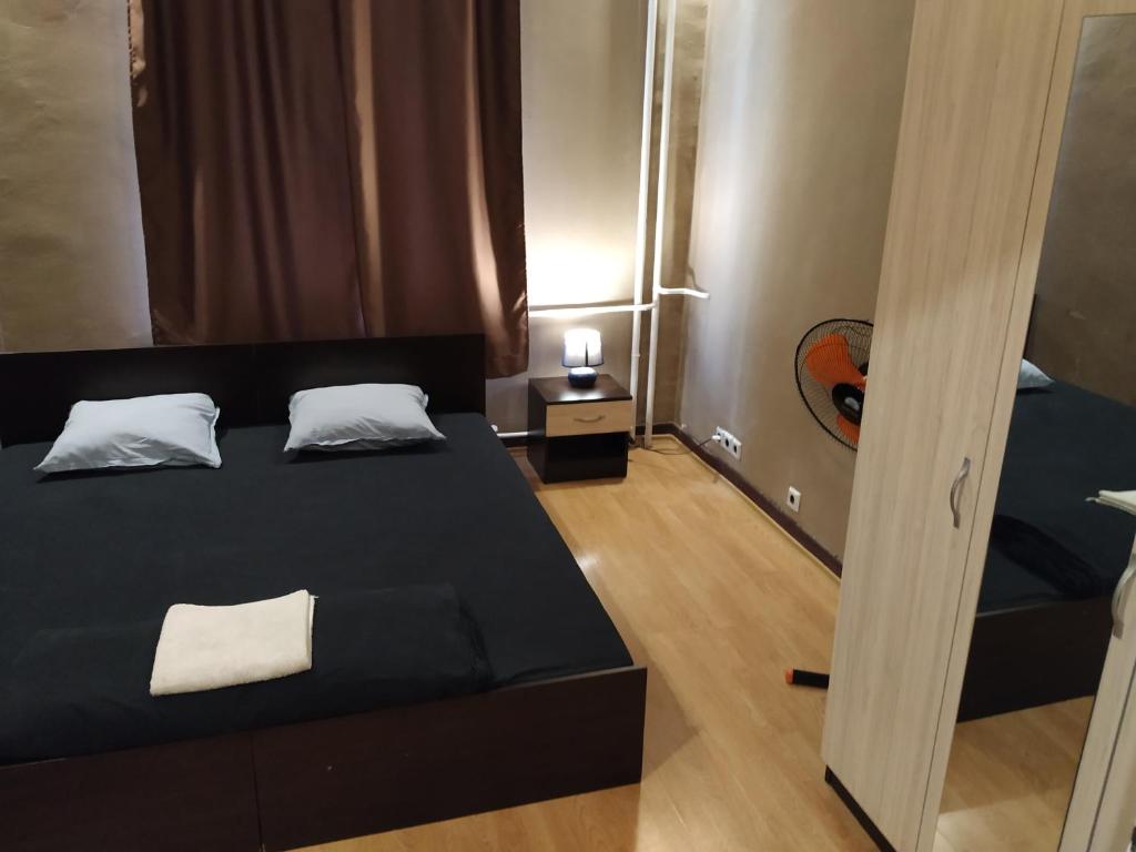 a small bedroom with two beds and a mirror at Best private rooms In the center in Sofia