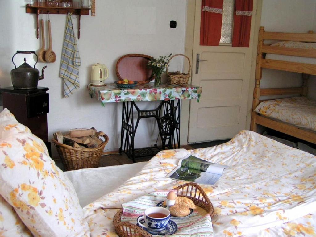 a bedroom with a bed with a table and a tableasonable at Farmer's Room at Sedliacky Dvor - Brezno in Brezno