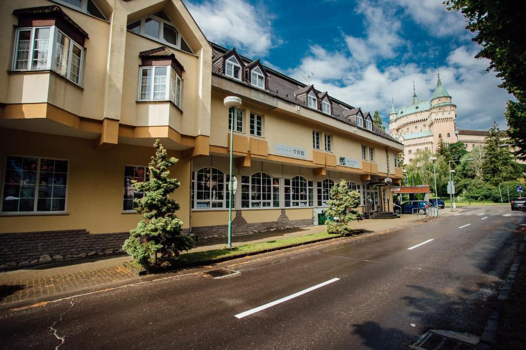 a building on the side of a street at Hotel pod Zámkom in Bojnice