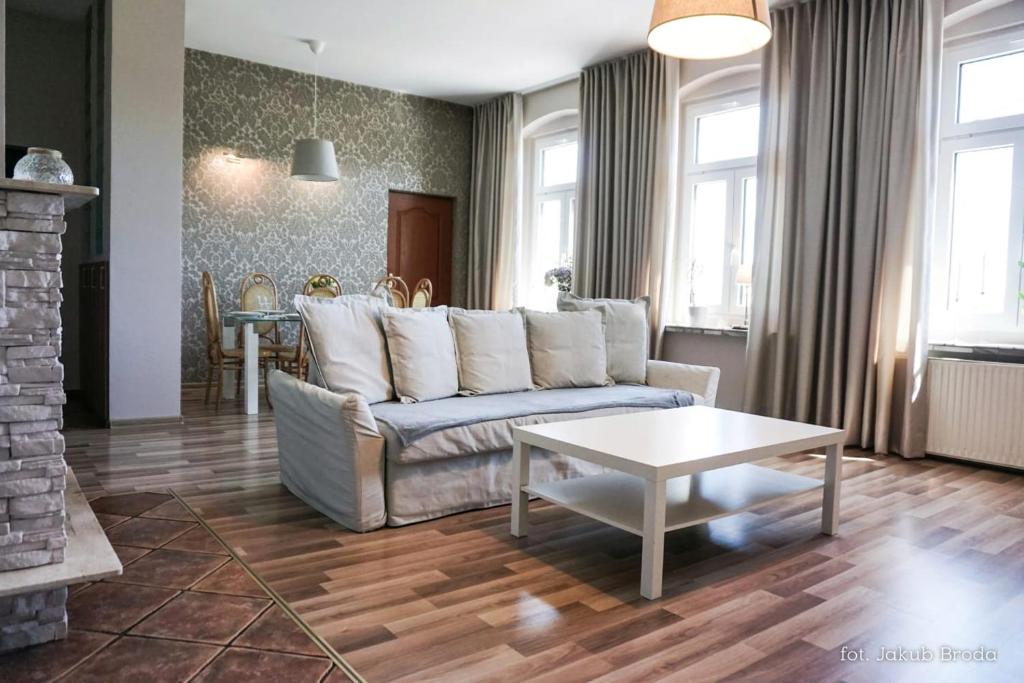 - un salon avec un canapé et une table dans l'établissement Apartamenty Toszeckie 4-6 osób, à Toszek