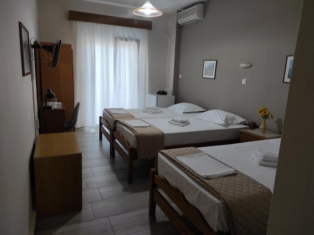 Postel nebo postele na pokoji v ubytování Ενοικιαζόμενα Δωμάτια Ενιπεύς- Rooms Enipeas