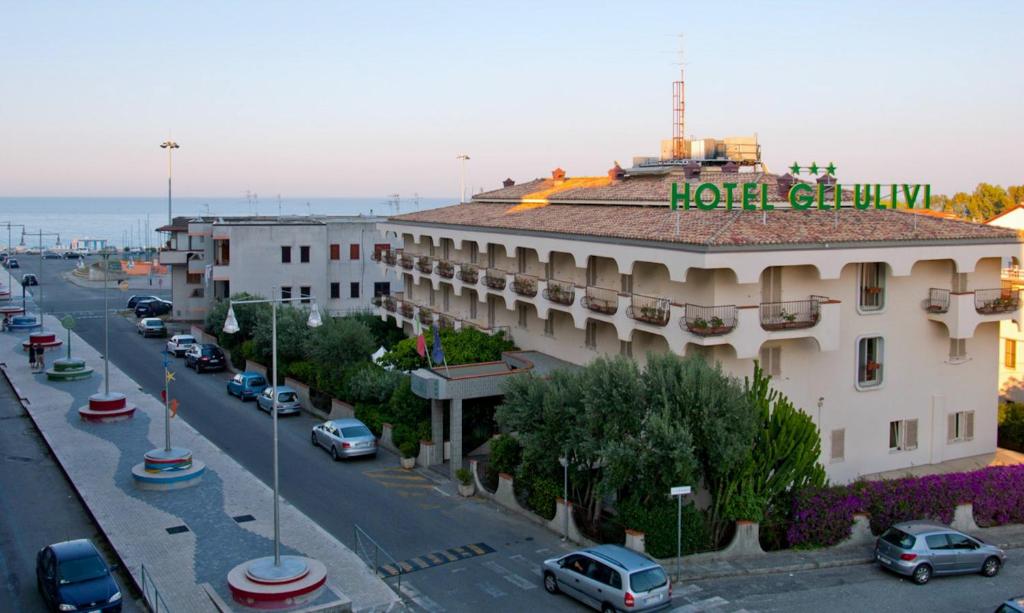 a building with a hotel sign on the top of it at Hotel Gli Ulivi in Soverato Marina