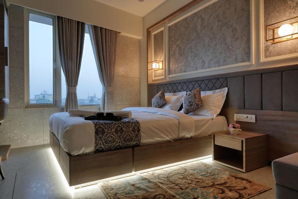 Postel nebo postele na pokoji v ubytování Hotel Elysian Residency