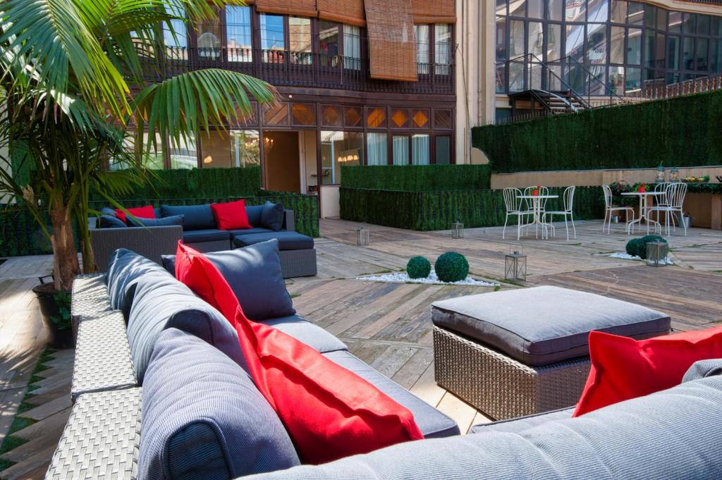 a courtyard with couches and tables in a building at BacHome Terrace B&B in Barcelona