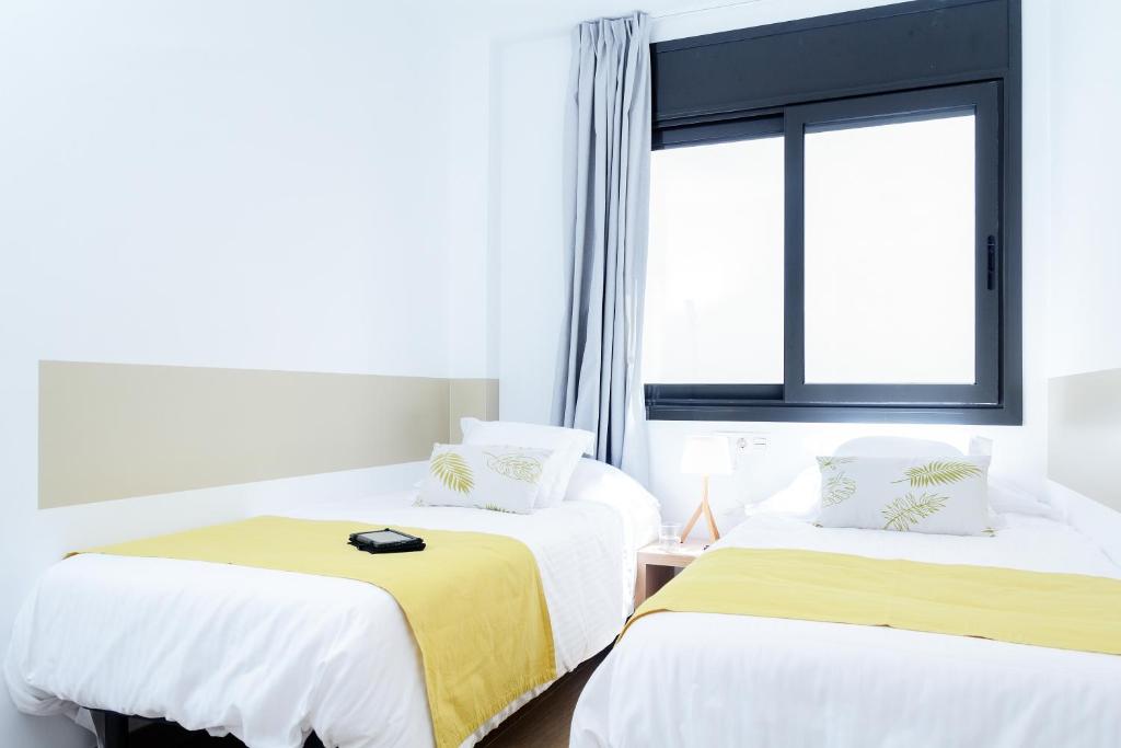 Posteľ alebo postele v izbe v ubytovaní Feelathome Plaza Apartments