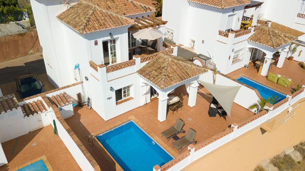 an aerial view of a house with a swimming pool at Villa privada con increíbles vistas al mar in Torrox Costa