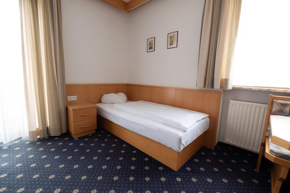 Postel nebo postele na pokoji v ubytování Garni Volgger