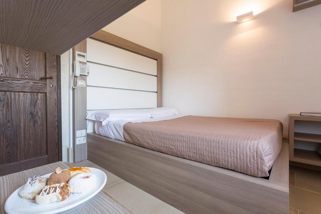 A bed or beds in a room at Antico Convento Dei Cappuccini