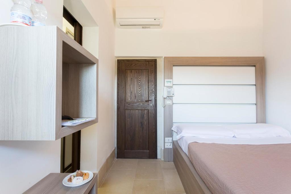 A bed or beds in a room at Antico Convento Dei Cappuccini
