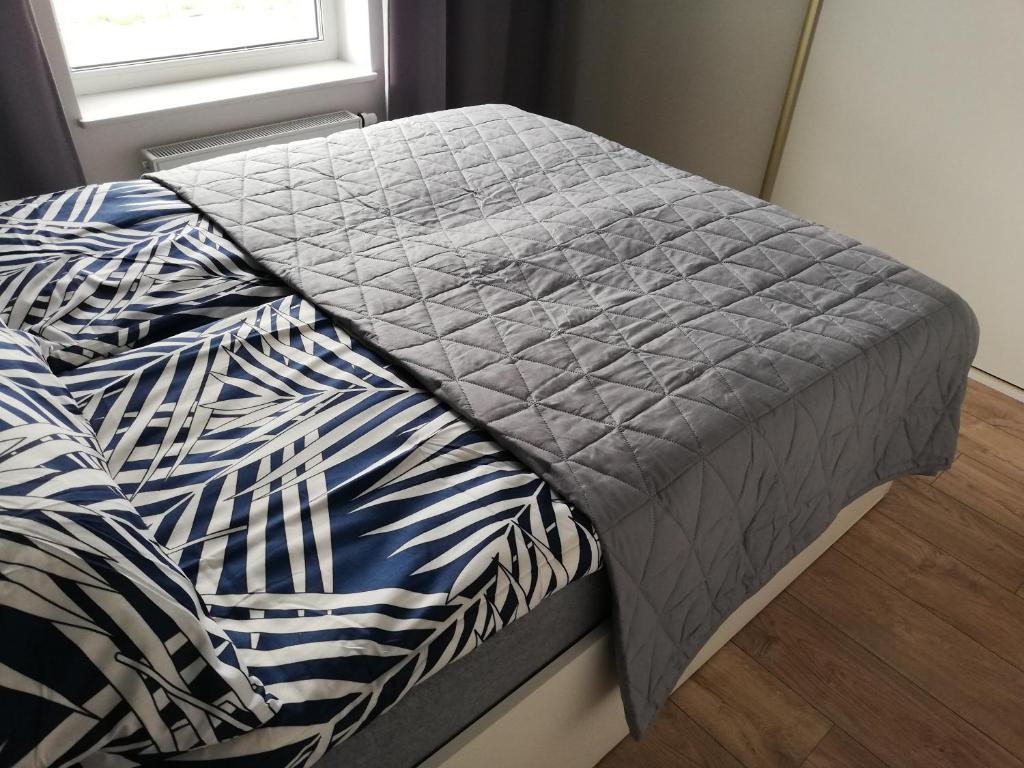 Posteľ alebo postele v izbe v ubytovaní Apartament Szmaragdowy