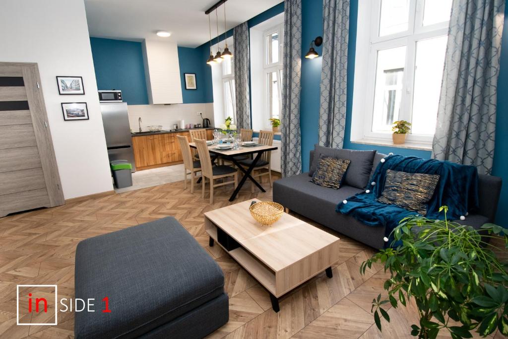 a living room with a couch and a table at Apartament INSIDE - centrum Bielsko-Biała in Bielsko-Biała