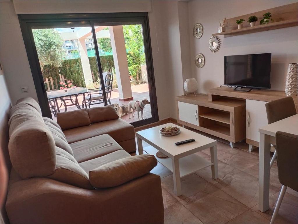 a living room with a couch and a table at Panorámica Golfmar c/ Generalitat in Sant Jordi