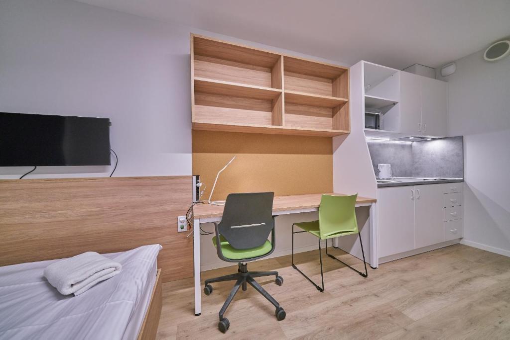 Televízia a/alebo spoločenská miestnosť v ubytovaní Apartamenty Collegia