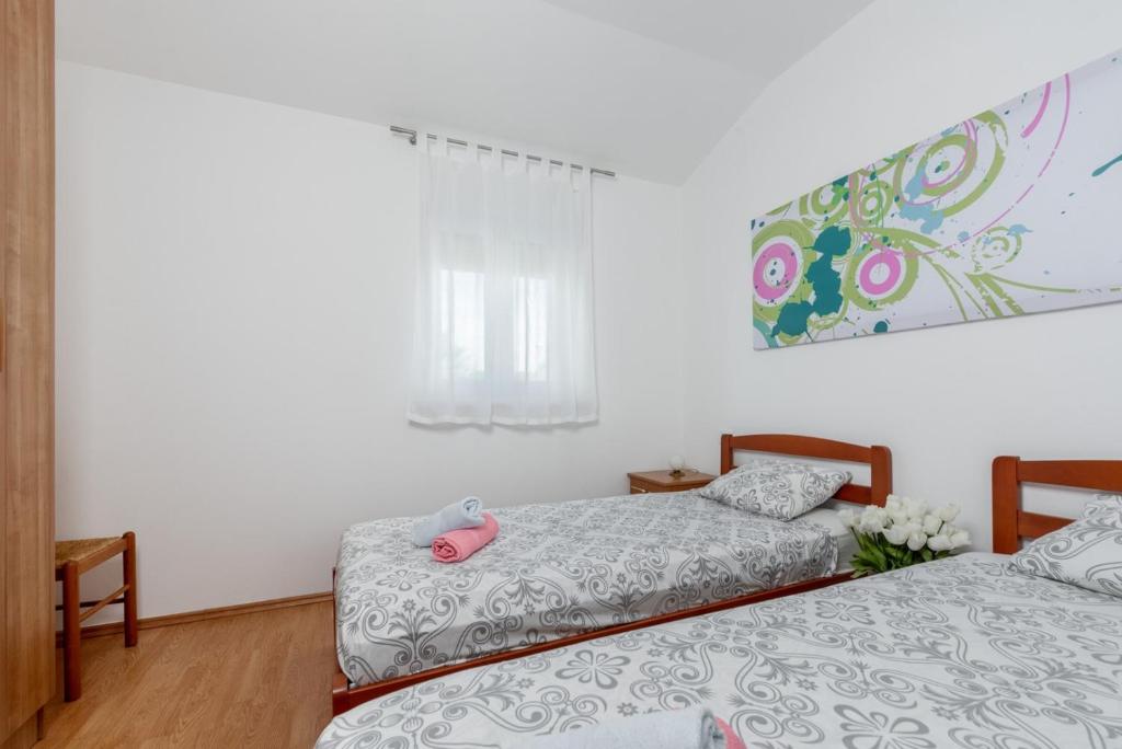 Posteľ alebo postele v izbe v ubytovaní Holiday House Dora