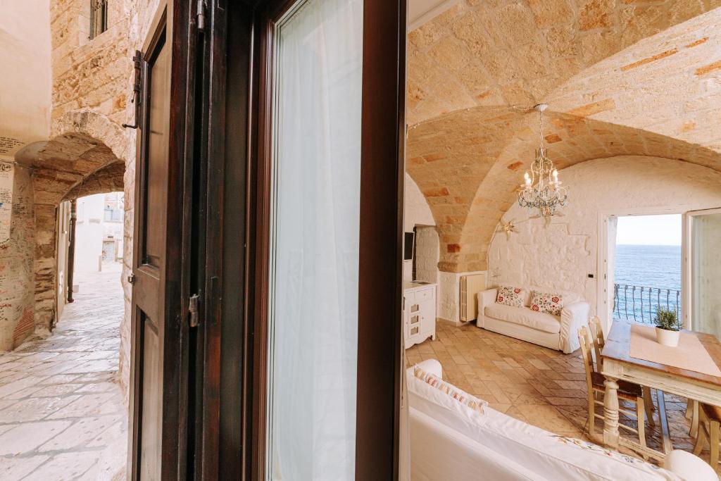 a living room with a view of the ocean at Tre Archi Suite & Relais in Polignano a Mare