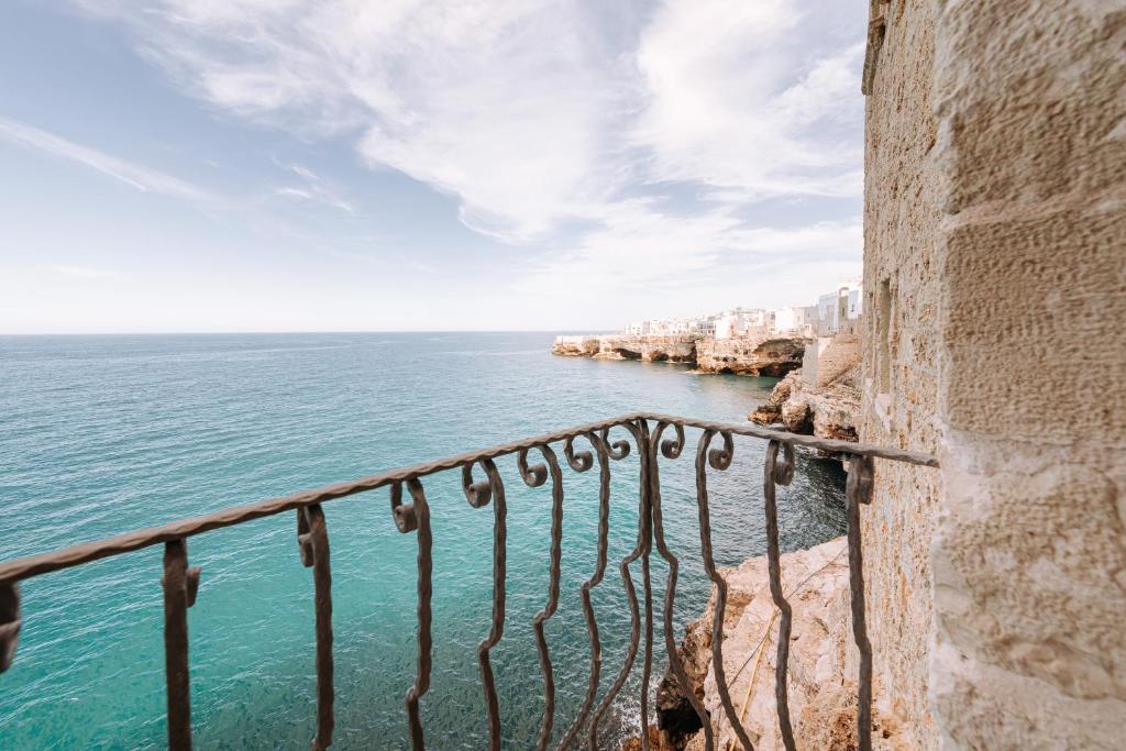 a view of the ocean from a balcony at Tre Archi Suite & Relais in Polignano a Mare